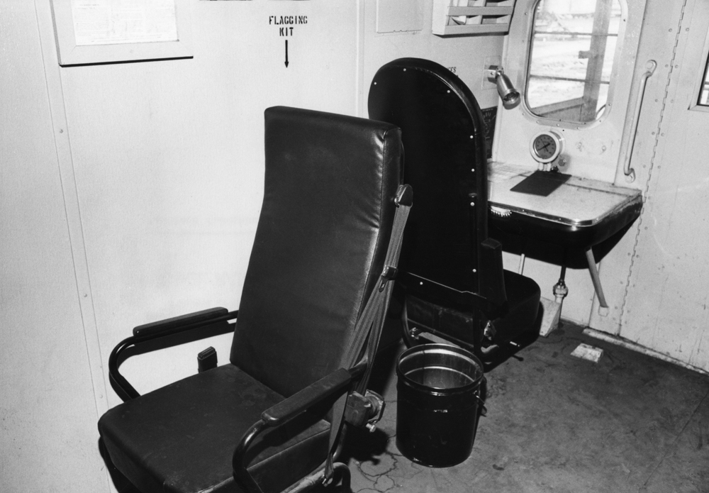 Black-and-white photo of caboose interior.