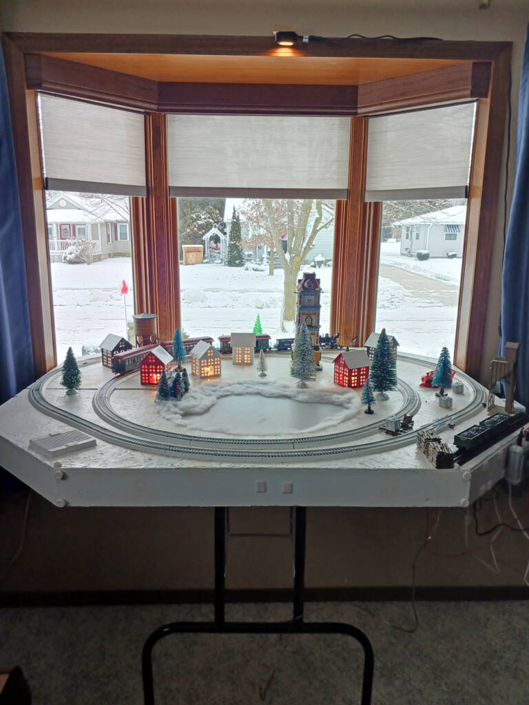 A model train layout in a bay window