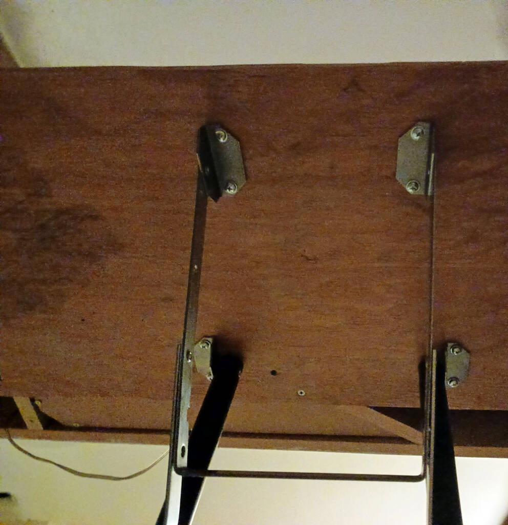 Banquet table leg brackets under a train layout