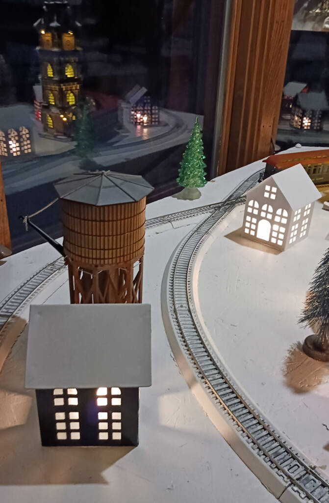 A water tower and crew house on a winter train layout