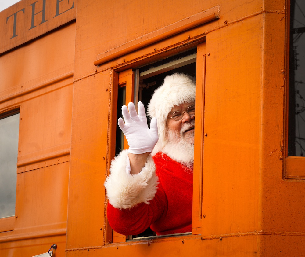 Santa Claus waving from a caboose