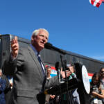 Man speaking with passenger train in background