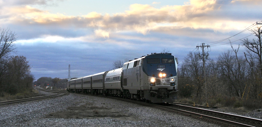 Passenger train with sunset as backdrop