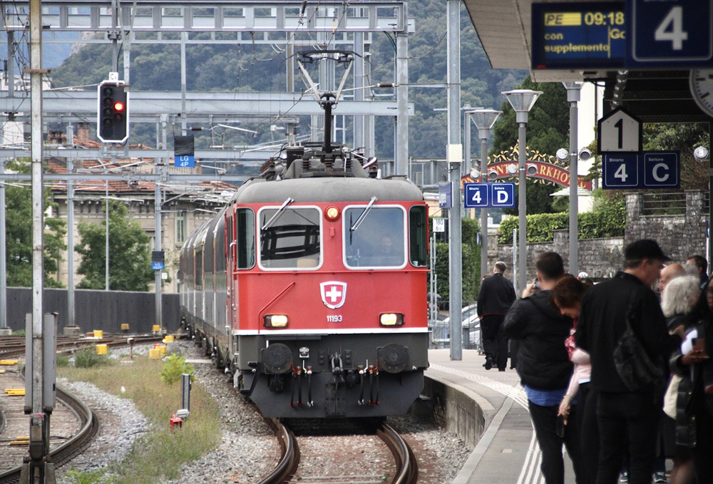 Red locomotive with passenger train