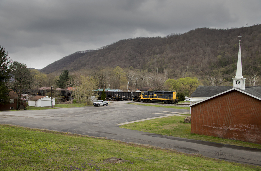 Black and yellow locomotive in mountain community