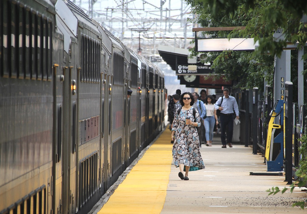 People on station platform next to train