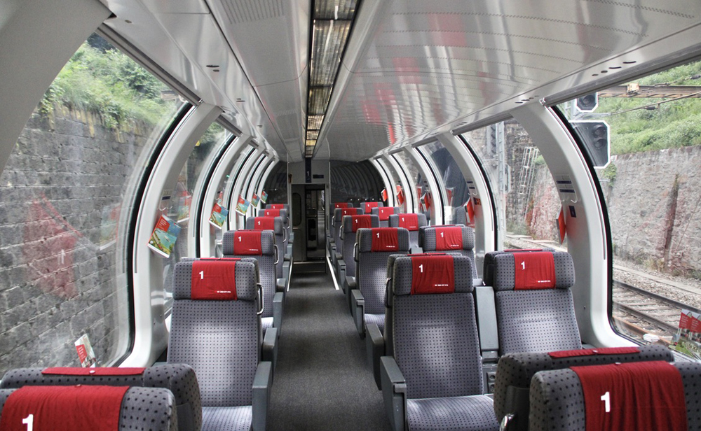 Inside of passenger car with large curving windows