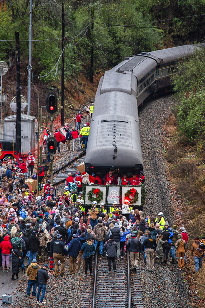 Crowd around observation car on stopped train