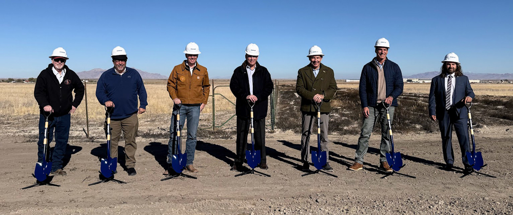 Seven people posing with shovels