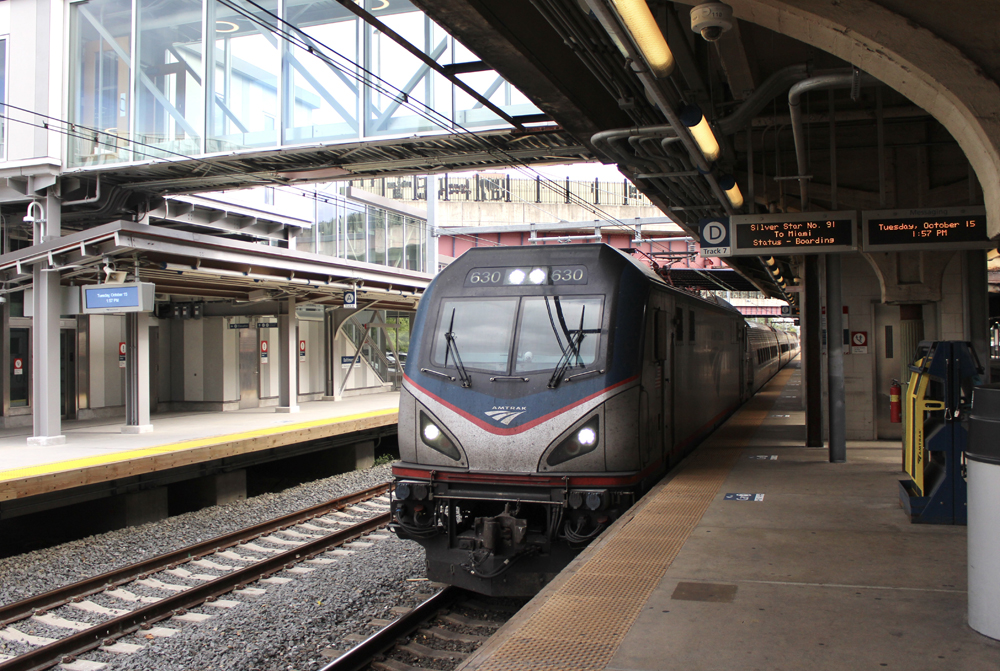 Long distance train with electric locomotive at station