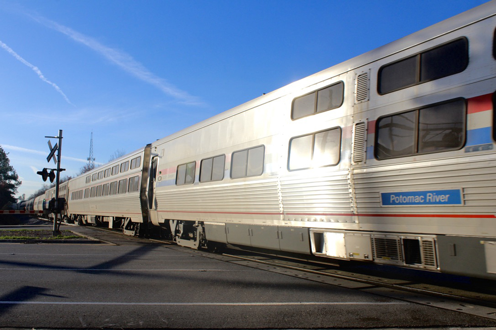 Passenger cars on train at grade crossing