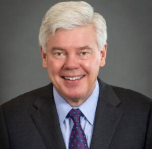 Smiling white-haired man in suit