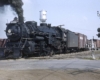 Smoking Grand Trunk Western steam locomotive in road crossing