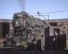 Grand Trunk Western steam locomotive on turntable by red wooden roundhouse