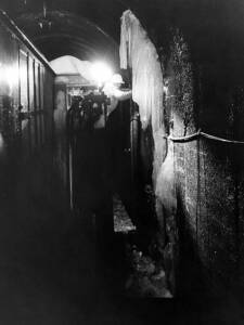 Man on locomotive walkway inside ice-filled tunnel