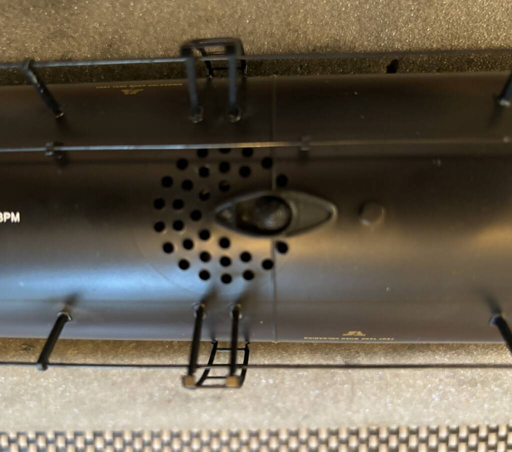 bottom of tank car showing holes for speaker