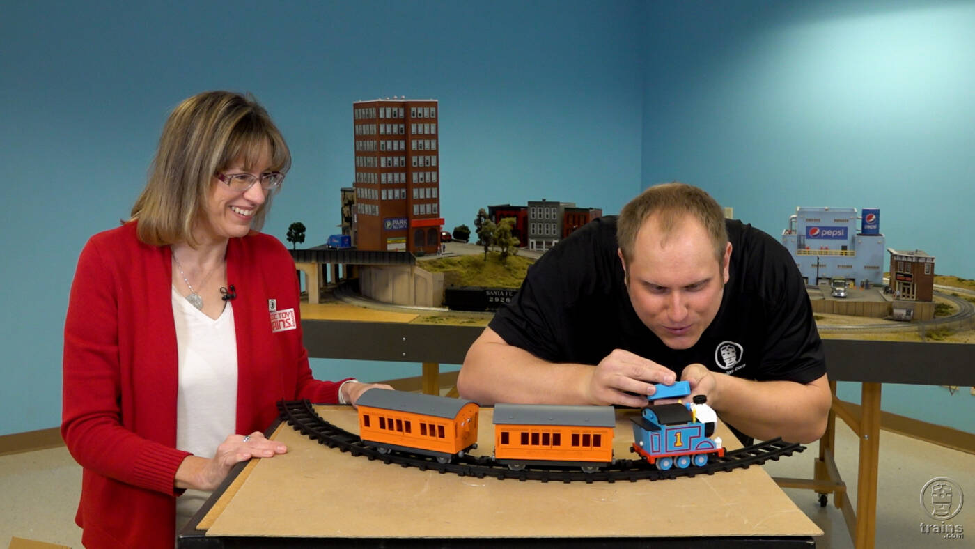 woman and man next to toy train set