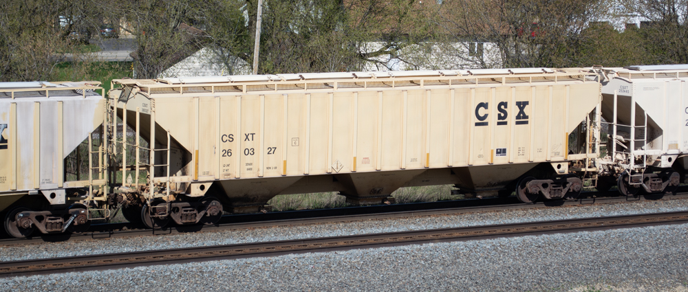 Color photo of prototype covered hopper painted tan with black graphics.