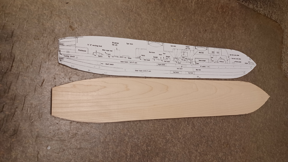 Color photo showing drawing and piece of wood cut to the same profile.