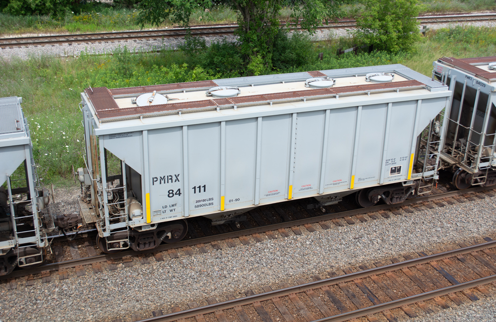 Color photo of gray two-bay covered hopper