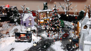 A model Christmas tree stands in a town square