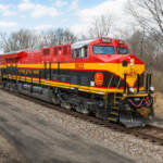 red, yellow, and black locomotive on track