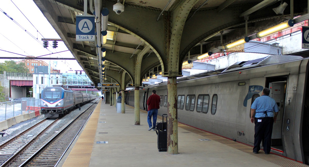 Train stopped at station platform as another approaches