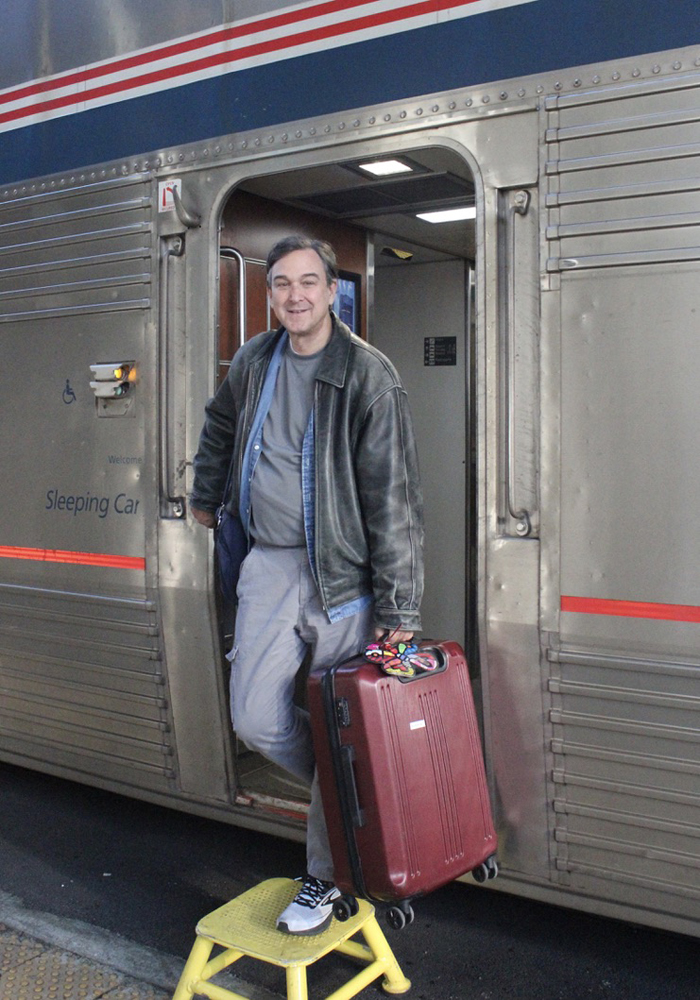 Man stepping off Amtrak Superliner passenger car