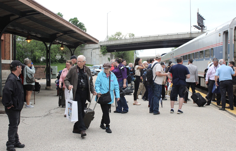 Large number of people waiting to board train at station