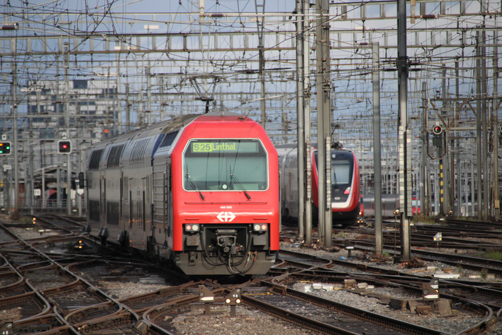 Two trains in maze of tracks and catenary