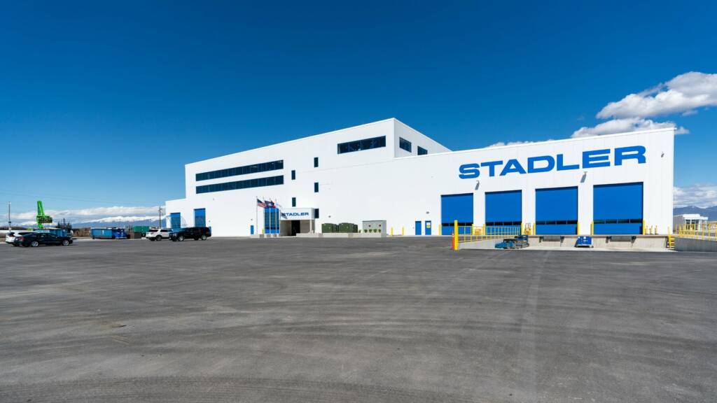 White factory building with blue doors