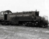 Black end-cab diesel locomotive in empty rail yard