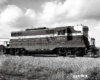 Striped mid-cab diesel locomotive under cloudy 