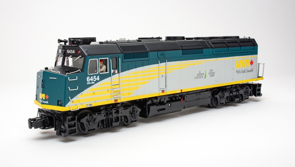 side of silver, yellow, and green model locomotive