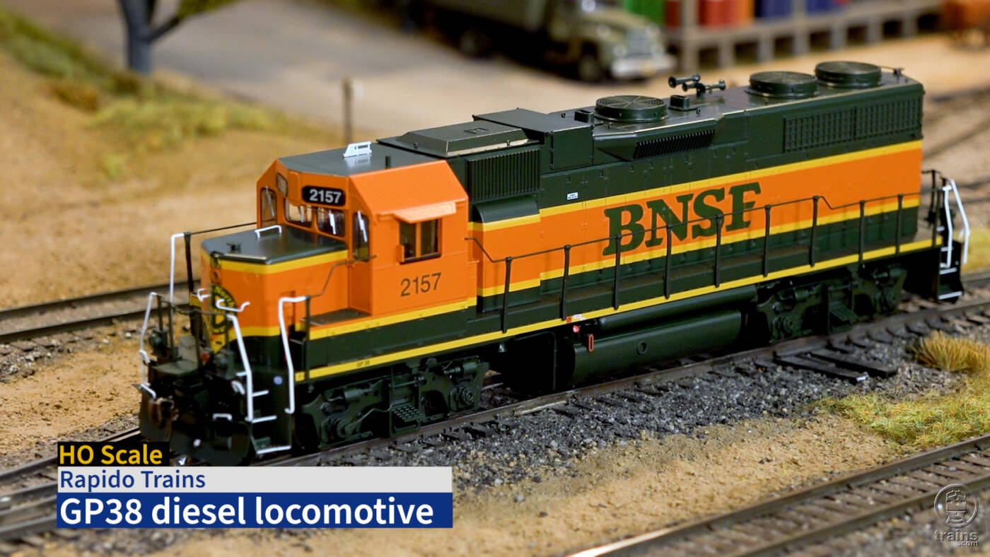 Title screen of product review video showing HO diesel in orange, green, and yellow paint with BNSF lettering.