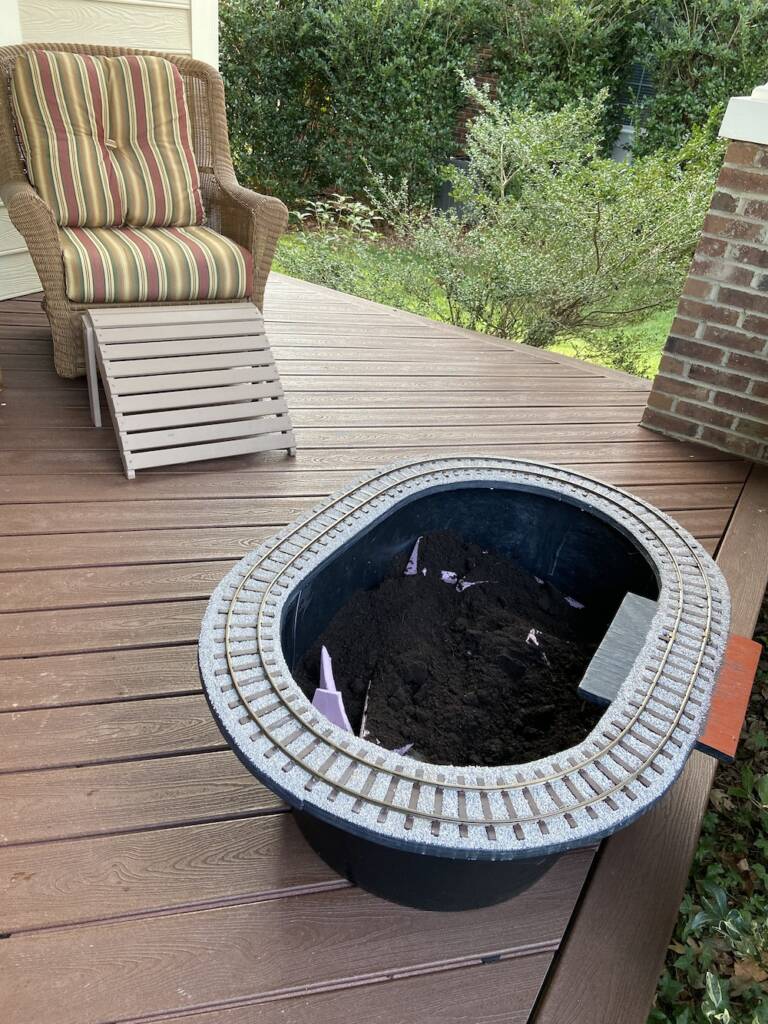 planter on a deck with patio chair in the background