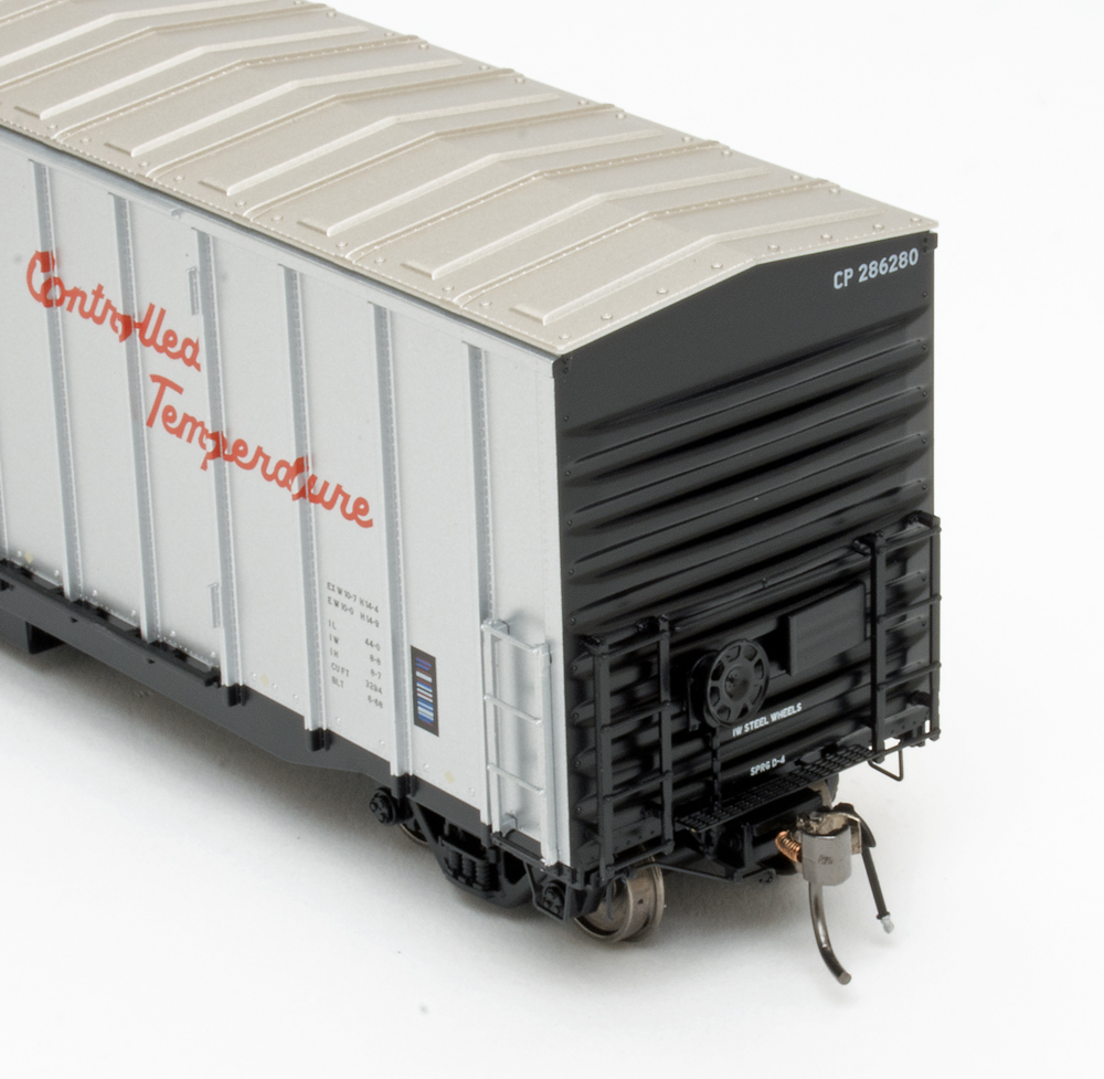 Color photo showing B end of HO scale freight car painted silver and black. 