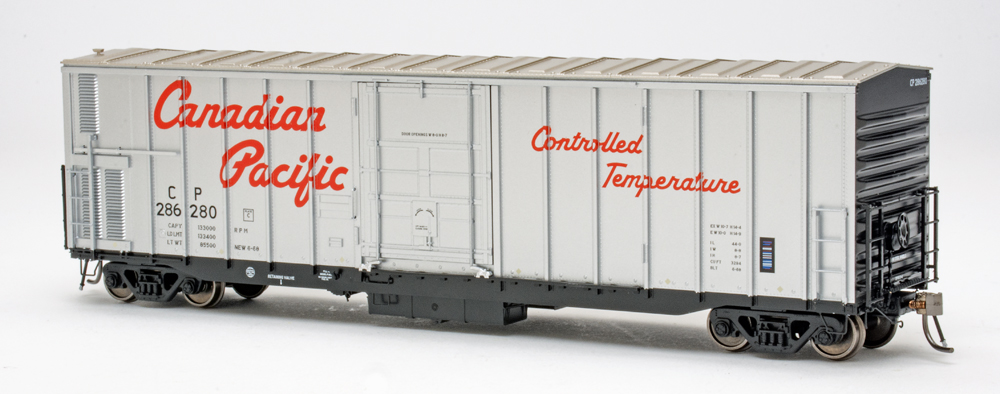 Color photo of HO scale freight car painted silver and black on white background.