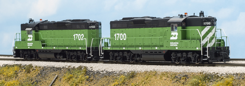 Color photo of two HO scale diesels in green and black paint.