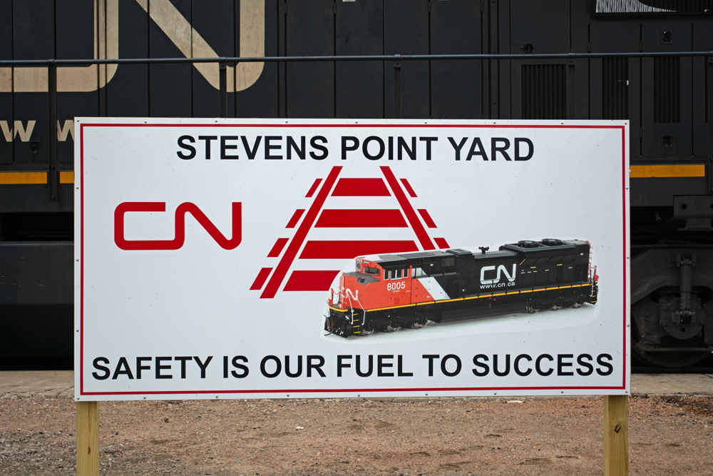 Color photo of sign in front of diesel locomotive.