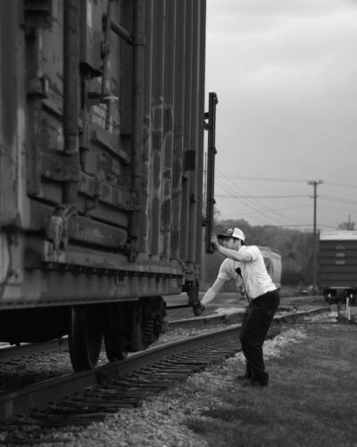 Young individual working on a freight car.