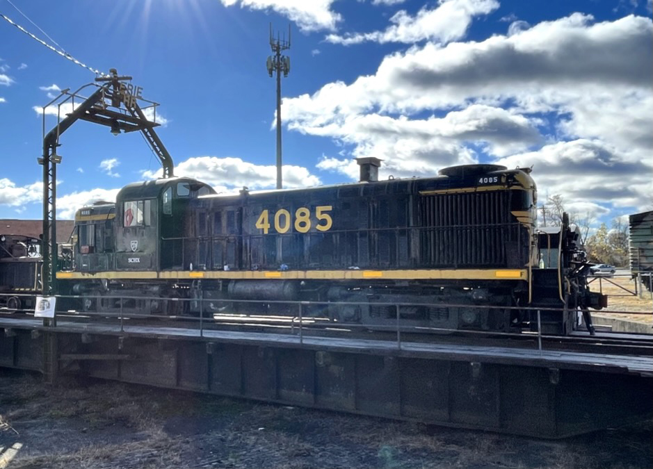 Blue road-switcher locomotive with yellow trim and lettering