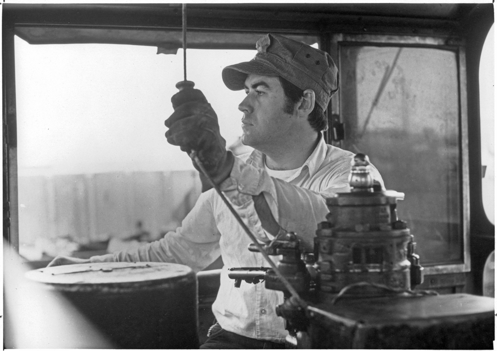 Black and whilte photo of man operating locomotive