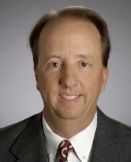 Head shot of man in coat and tie