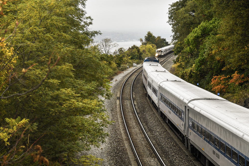 Two commuter trains meet on line next to river