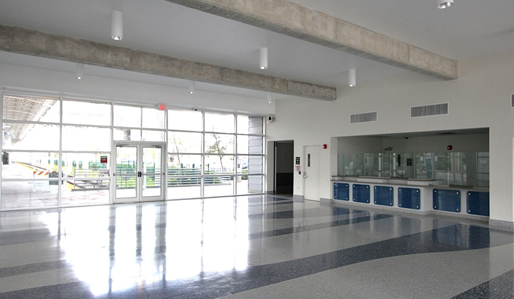 Station interior with empty seating area and unfinished ticket windows