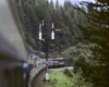 Multi-colored passenger train with two-mast semaphore signals on curve