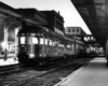 Streamlined stainless steel locomotives at station with platform canopies 