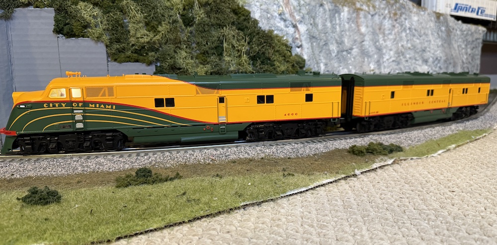 yellow and green model train on track