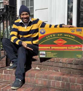 man next to set box of model train